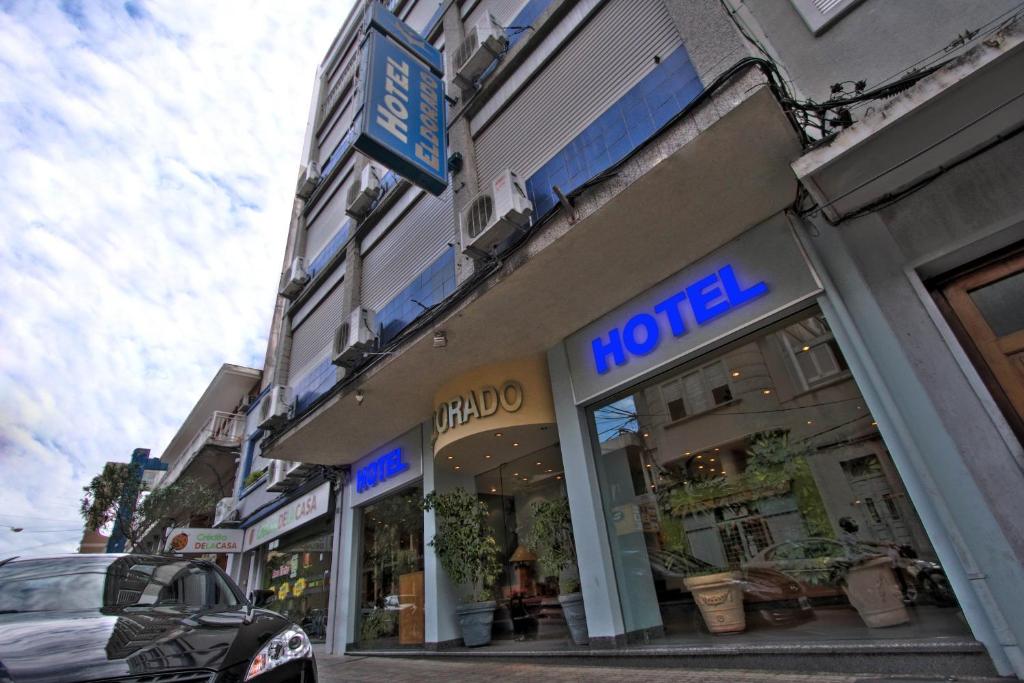 a building with a hotel sign on the side of a street at Hotel Eldorado in Salto