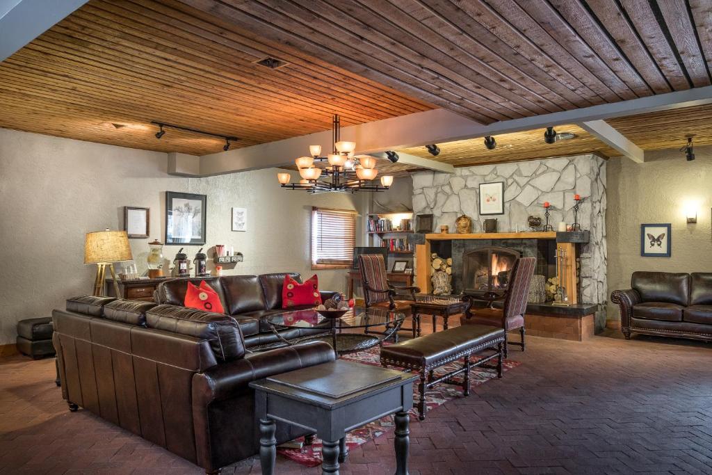 a living room with leather furniture and a fireplace at Sweetwater Lift Lodge in Park City