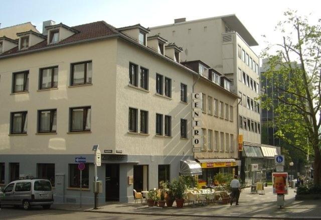 a large white building on a city street at Hotel Centro in Stuttgart