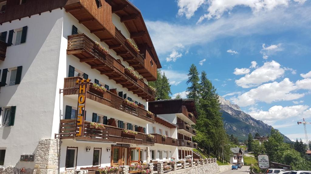 a building with balconies on the side of it at Hotel Des Alpes in Cortina dʼAmpezzo