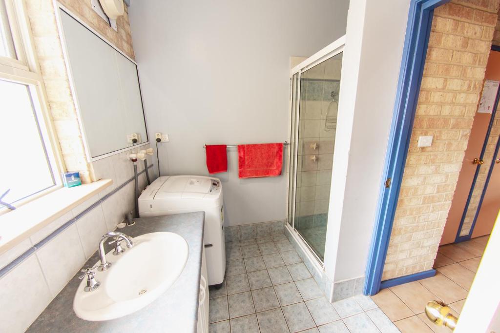 a bathroom with a toilet and a sink and a shower at Esperance Foreshore Apartments in Esperance