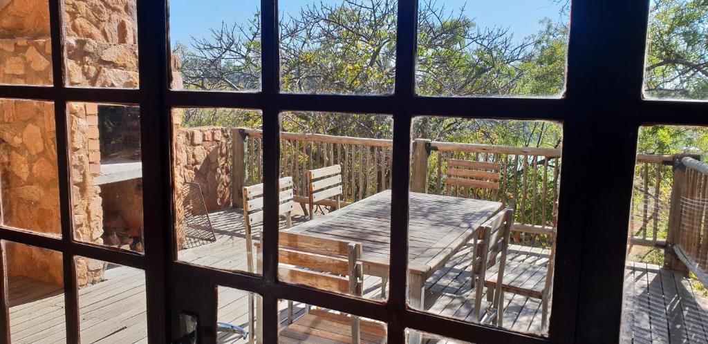 a view from a window of a table on a deck at Milorho Lodge in Rietfontein