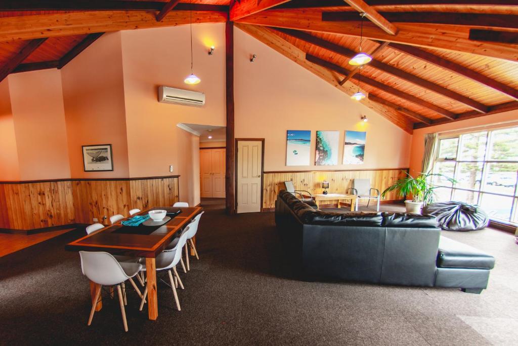 a living room with a couch and a table at Yot Spot Apartments in Esperance