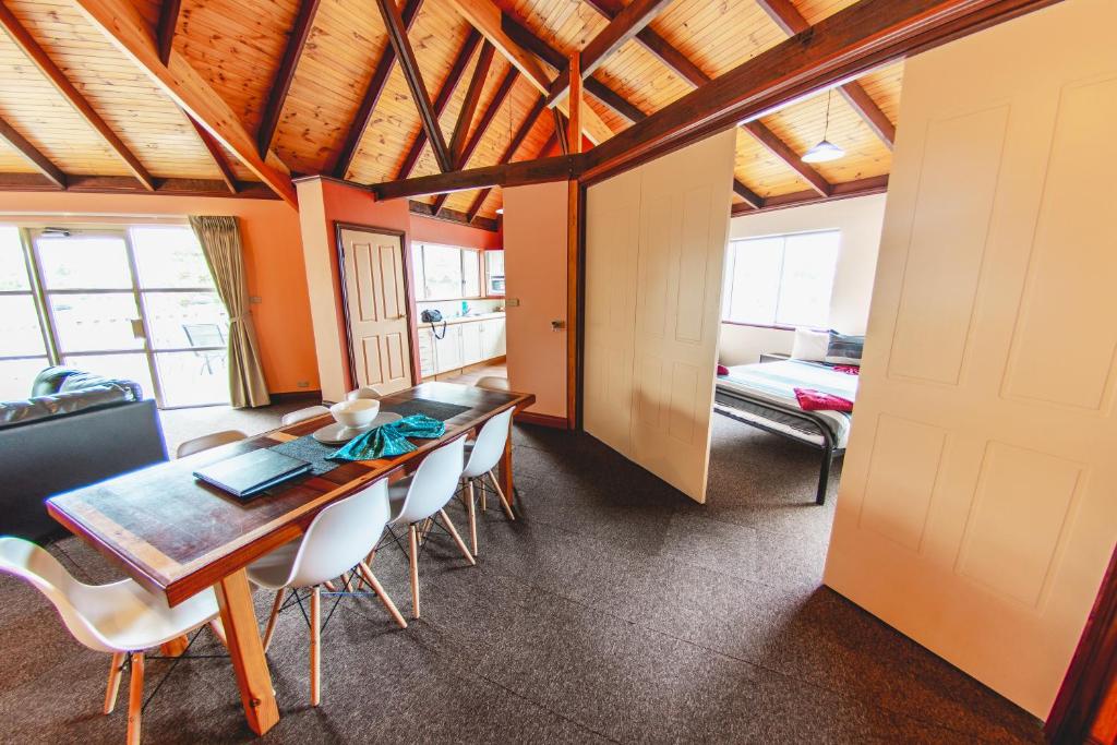 a dining room with a wooden table and chairs at Esperance Foreshore Apartments in Esperance