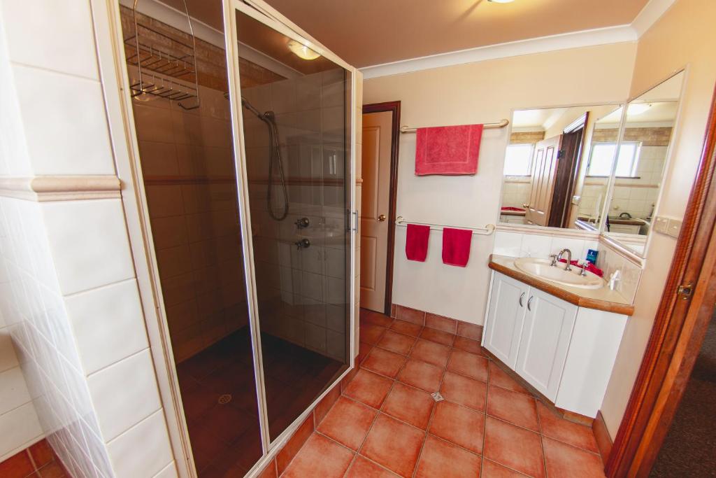 a bathroom with a shower and a sink at Esperance Foreshore Apartments in Esperance