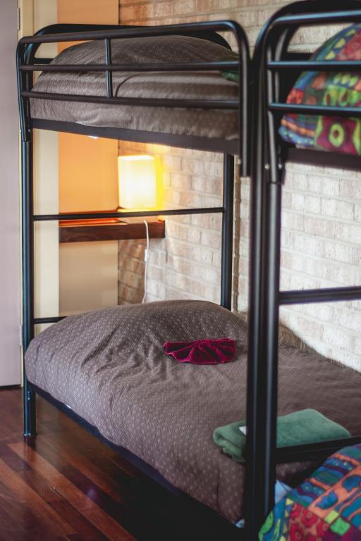 a bedroom with two bunk beds and a lamp at Esperance Foreshore Apartments in Esperance