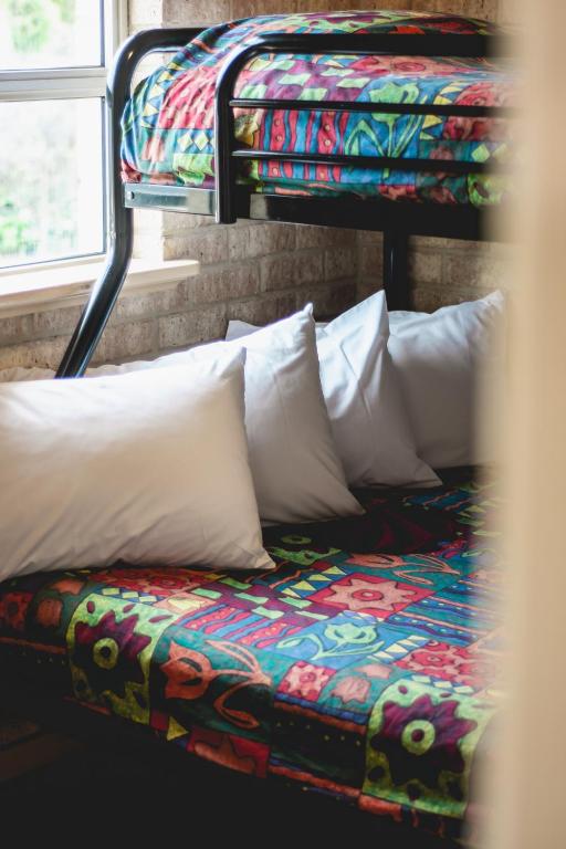 a bed with pillows on top of a bus at Esperance Foreshore Apartments in Esperance