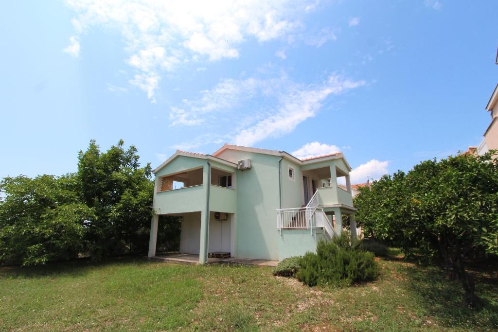 una casa en una colina con un cielo azul en Apartments Ines, en Orebić