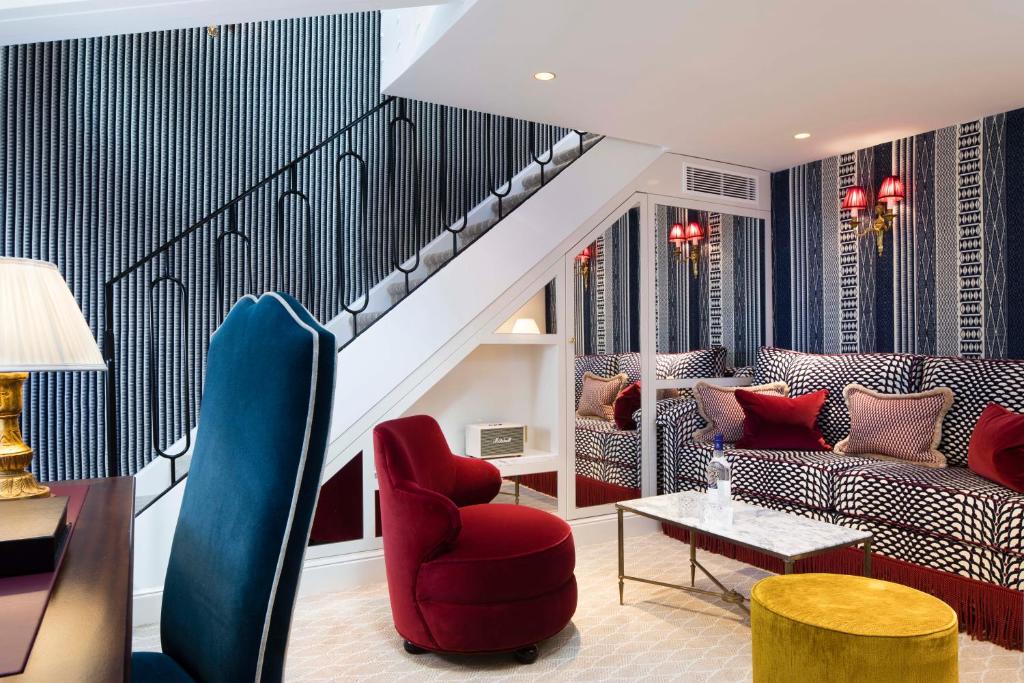 a living room with a couch and a table at Relais Christine in Paris