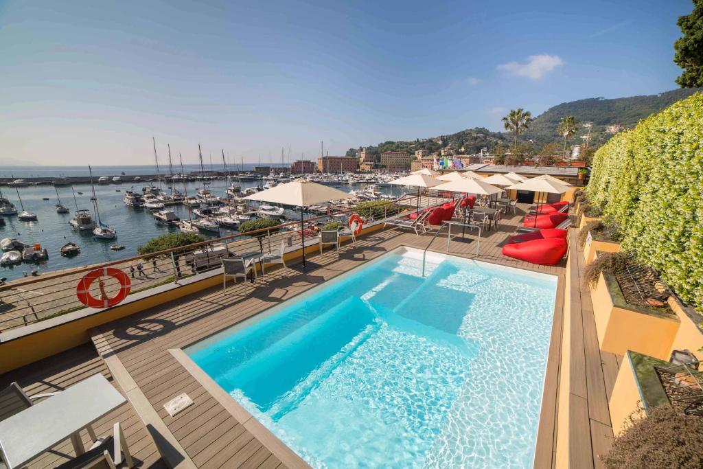 a pool on a balcony with a view of a marina at Hotel Laurin in Santa Margherita Ligure