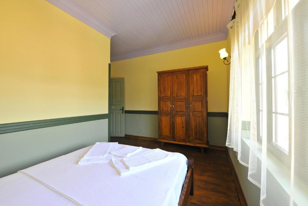 Postel nebo postele na pokoji v ubytování Petrino Gökçeada Hotel&Kitchen