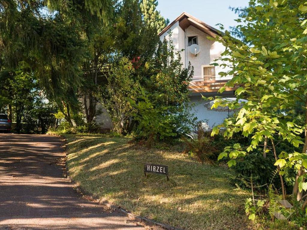 a sign in the grass in front of a house at Gästehaus Hirzel in Bad Wildbad