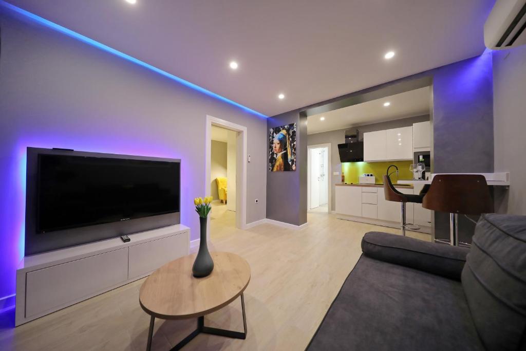a living room with a large flat screen tv at City Marine Luxury Apartments in Zadar