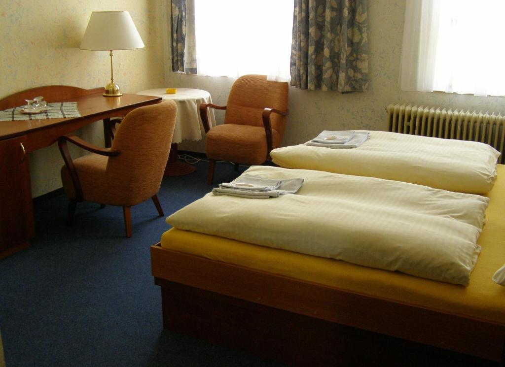 Postel nebo postele na pokoji v ubytování Hotel Goethe