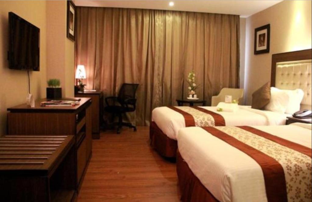 Postel nebo postele na pokoji v ubytování ACE Hotel and Suites