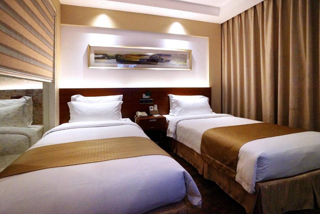 Postel nebo postele na pokoji v ubytování Maixinge Boutique Hotel Chuansha Branch