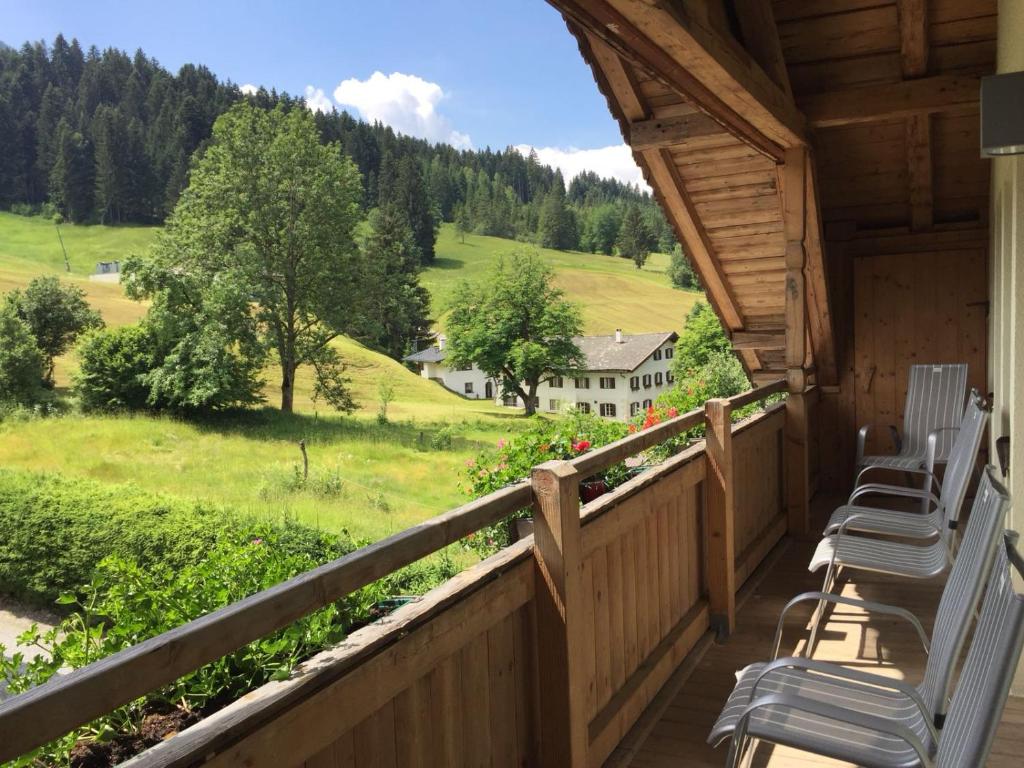 a porch with chairs and a view of a house at Haus Tirol in Brixen im Thale
