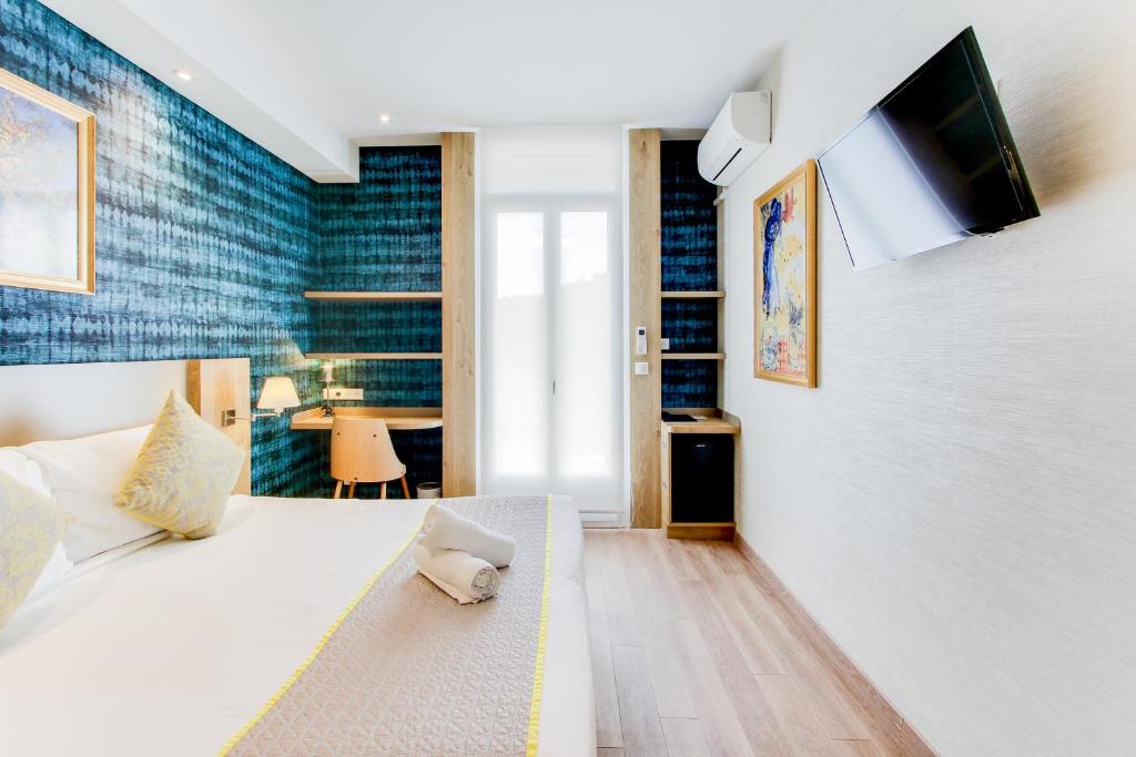 Postel nebo postele na pokoji v ubytování Hôtel Provençal