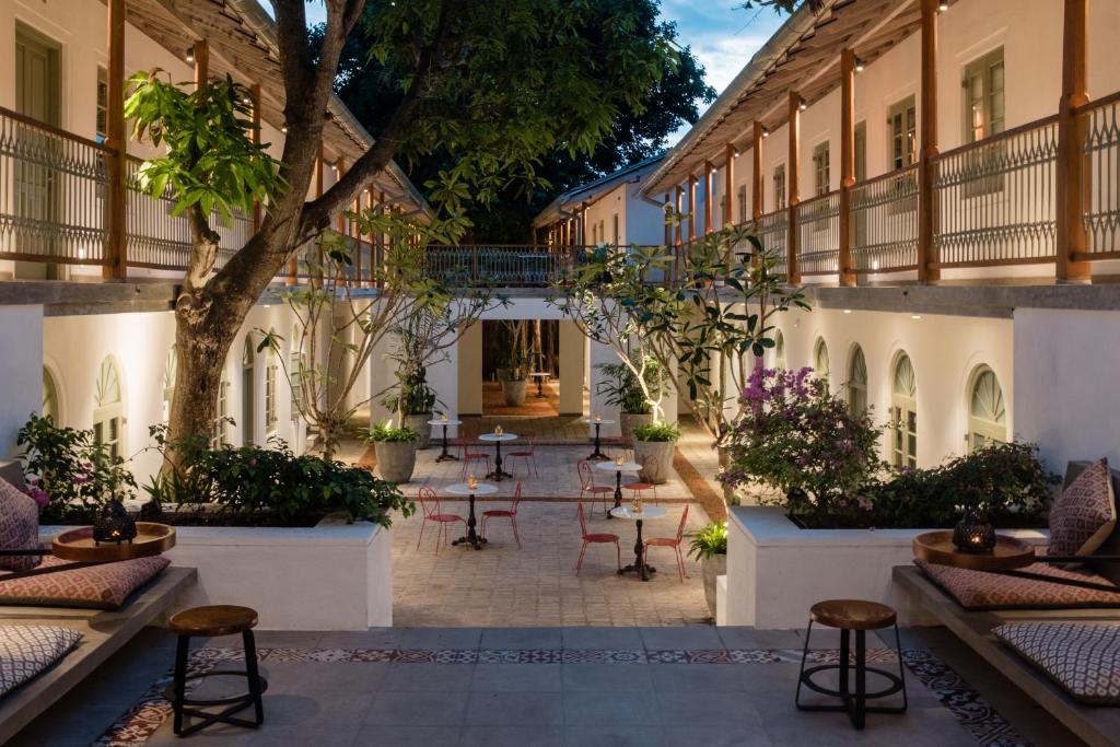 a courtyard with tables and chairs in a building at Fort Bazaar in Galle