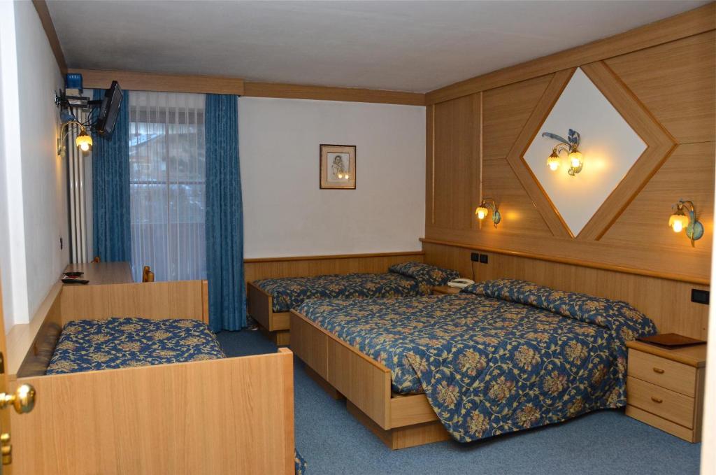Postel nebo postele na pokoji v ubytování Hotel Stella Alpina