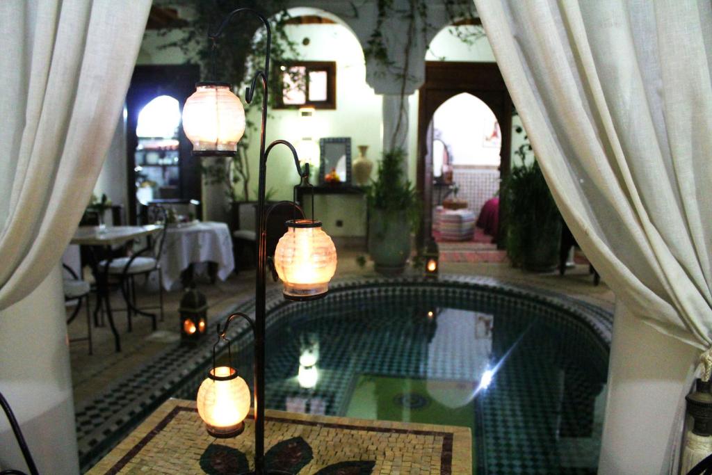 a house with a swimming pool in a room with curtains at Riad Alida in Marrakech