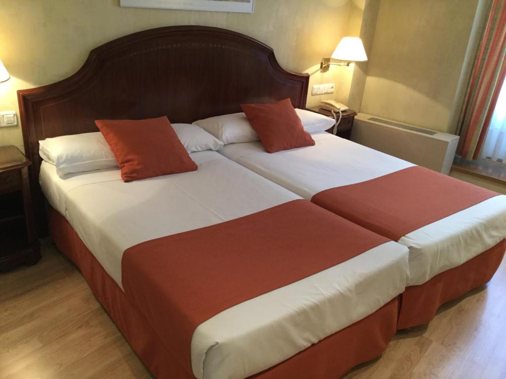 Postel nebo postele na pokoji v ubytování Hotel Cordón