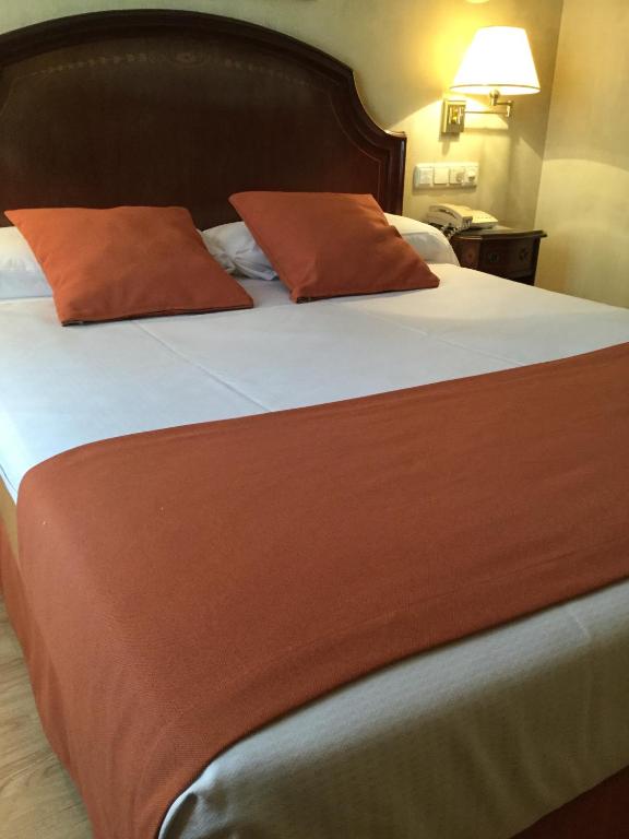 Postel nebo postele na pokoji v ubytování Hotel Cordón