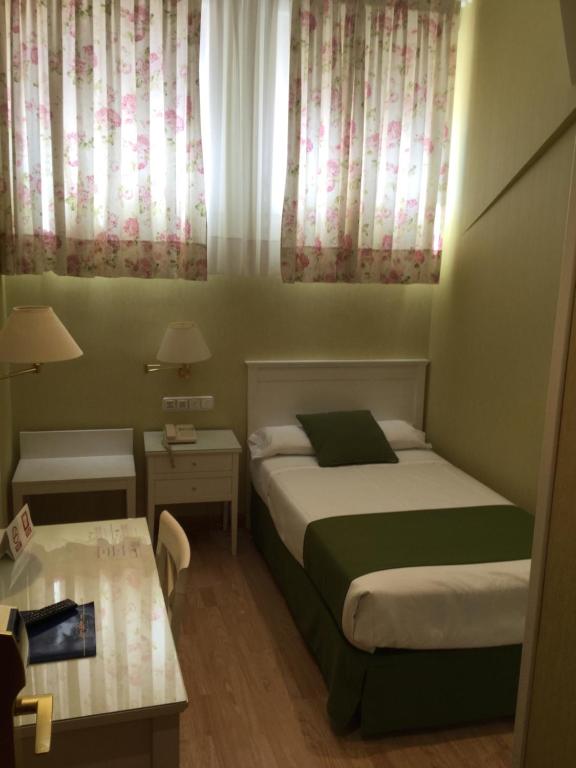 Postel nebo postele na pokoji v ubytování Hotel Cordón