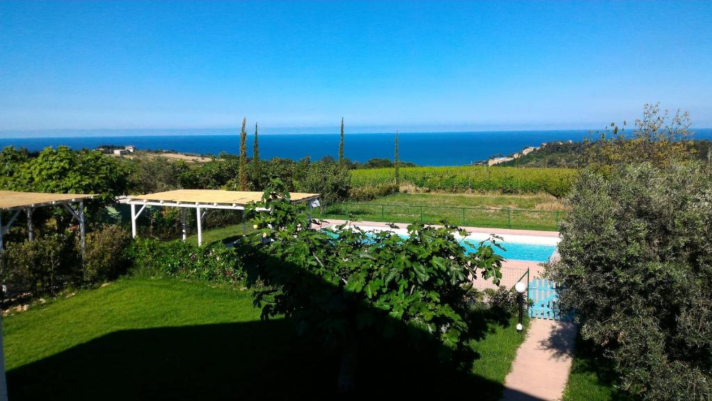 a view of a swimming pool and the ocean at Villa Marchetti in Cupra Marittima