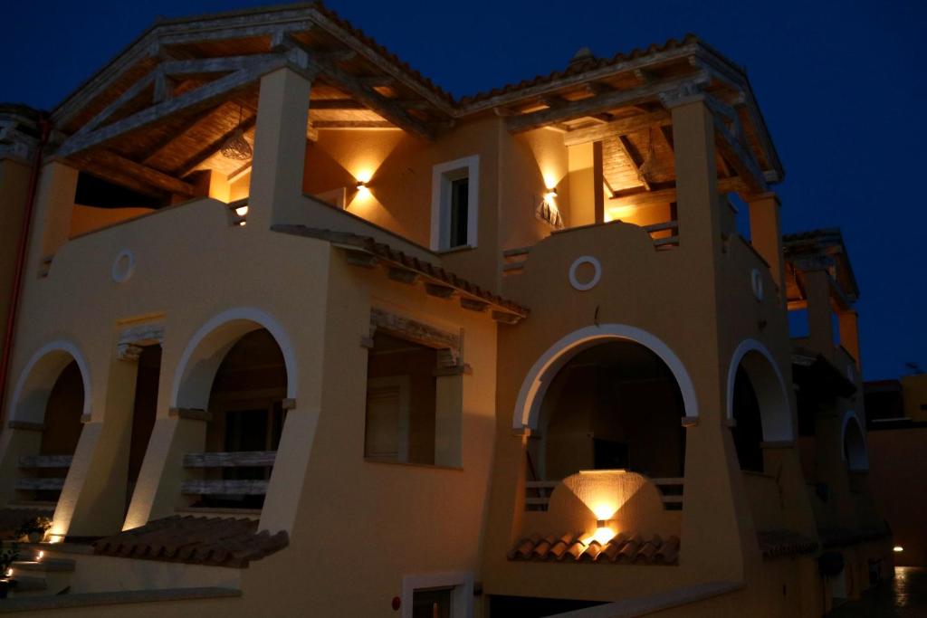 a house at night with lights on the balcony at La rosa dei venti in Villasimius