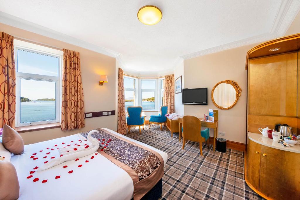 a hotel room with a bed and a table and chairs at Muthu Alexandra Hotel in Oban