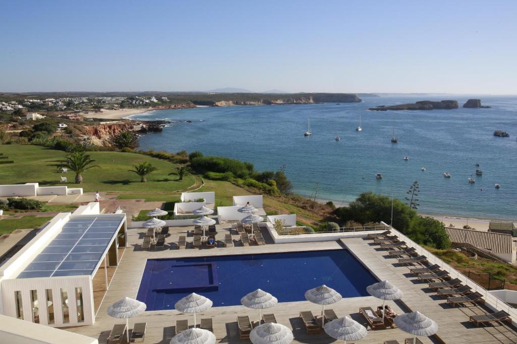 a resort with a swimming pool and a view of the ocean at Memmo Baleeira - Design Hotels in Sagres