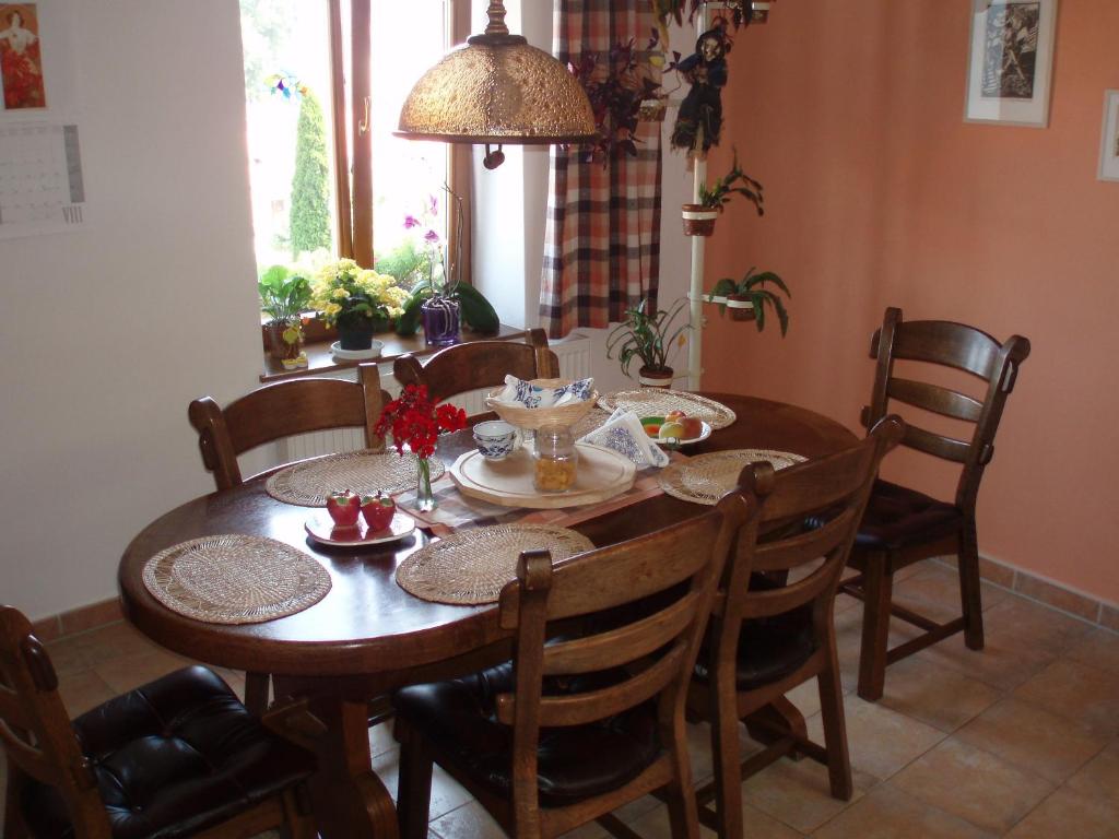 a dining room table and chairs with a table and a table at B&B Nika in Telč