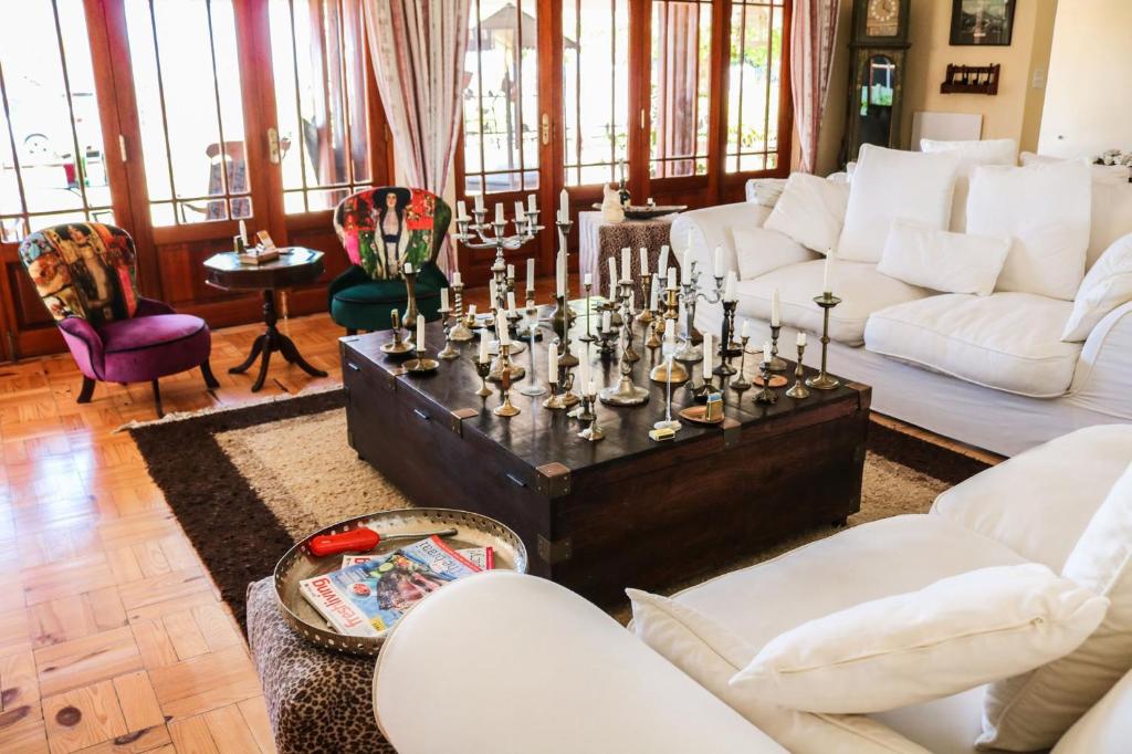 a living room with white couches and a coffee table at Goblin's Creek in St. Helena Bay