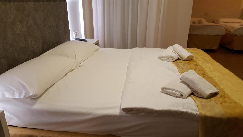 Postel nebo postele na pokoji v ubytování Hotel Righetto Fronte Mare