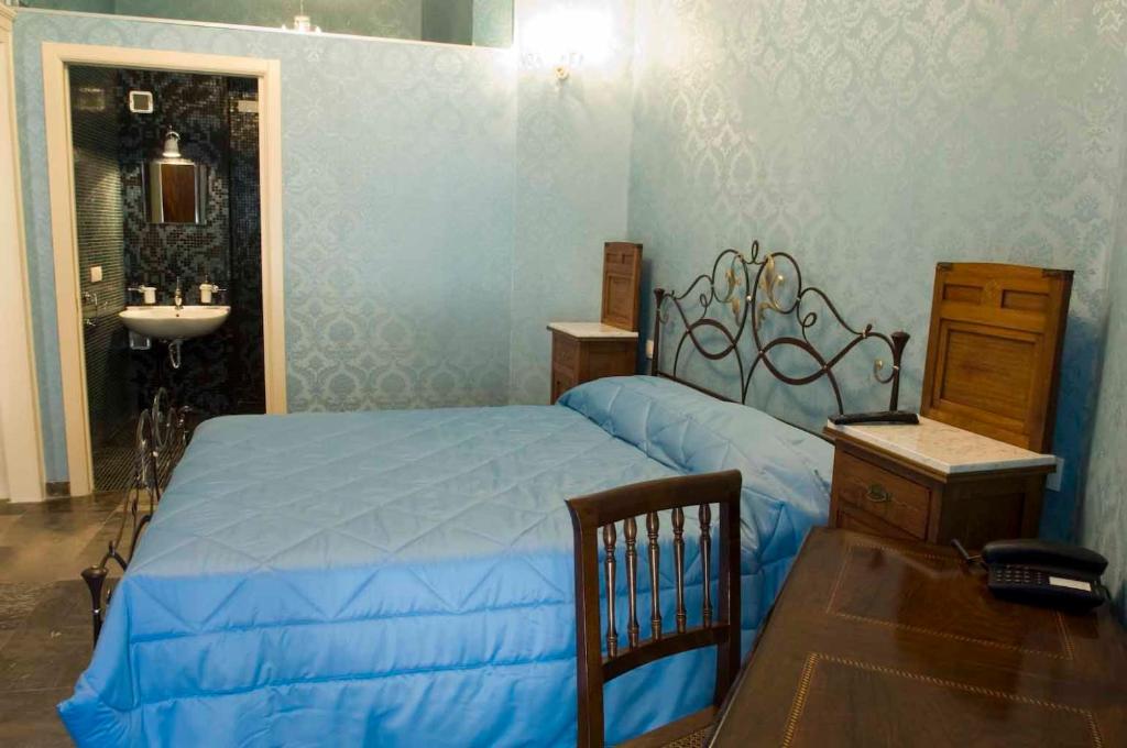 Postel nebo postele na pokoji v ubytování Grana Barocco Art Hotel