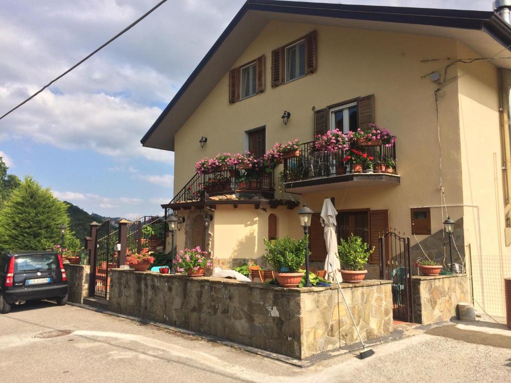 a house with potted plants and a balcony at La casa nel verde in Castelmezzano