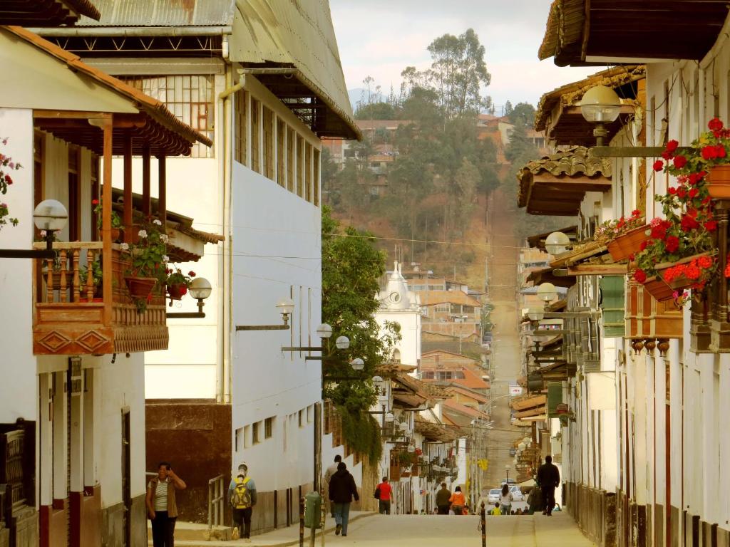 a city street with people walking down the street at Hotel Meflo Chachapoyas in Chachapoyas