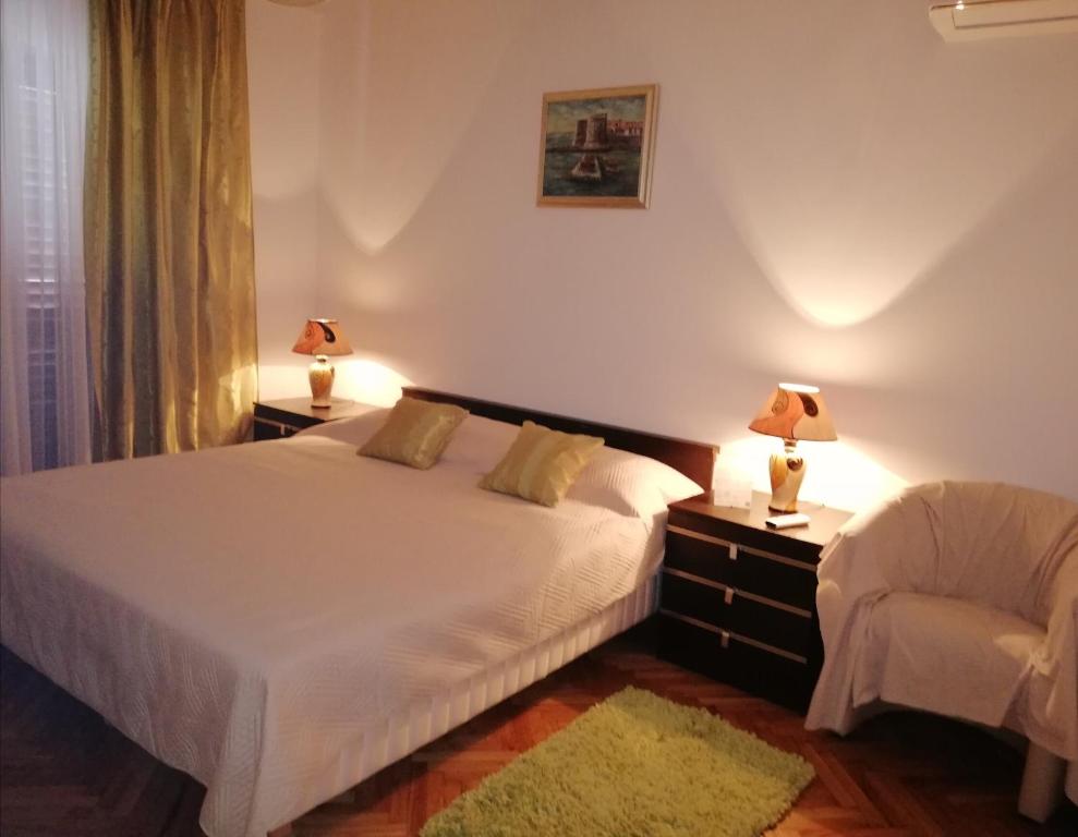 a bedroom with two beds and two lamps on tables at Rooms Radic in Dubrovnik