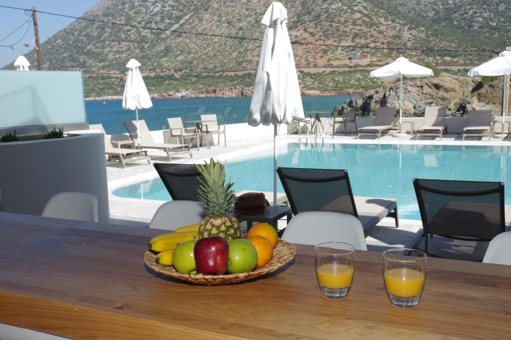 a bowl of fruit on a table next to a pool at Bali Diamond "by Checkin" Adults Only in Bali