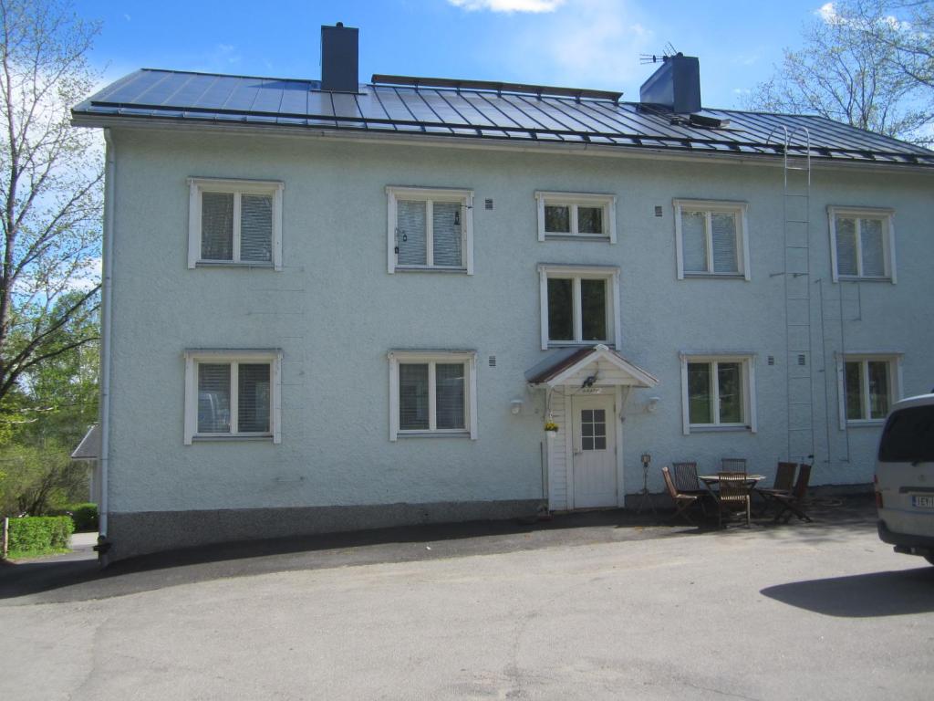 RISTIMÄENKATU 13 في سافونلينّا: منزل أبيض كبير مع سقف شمسي