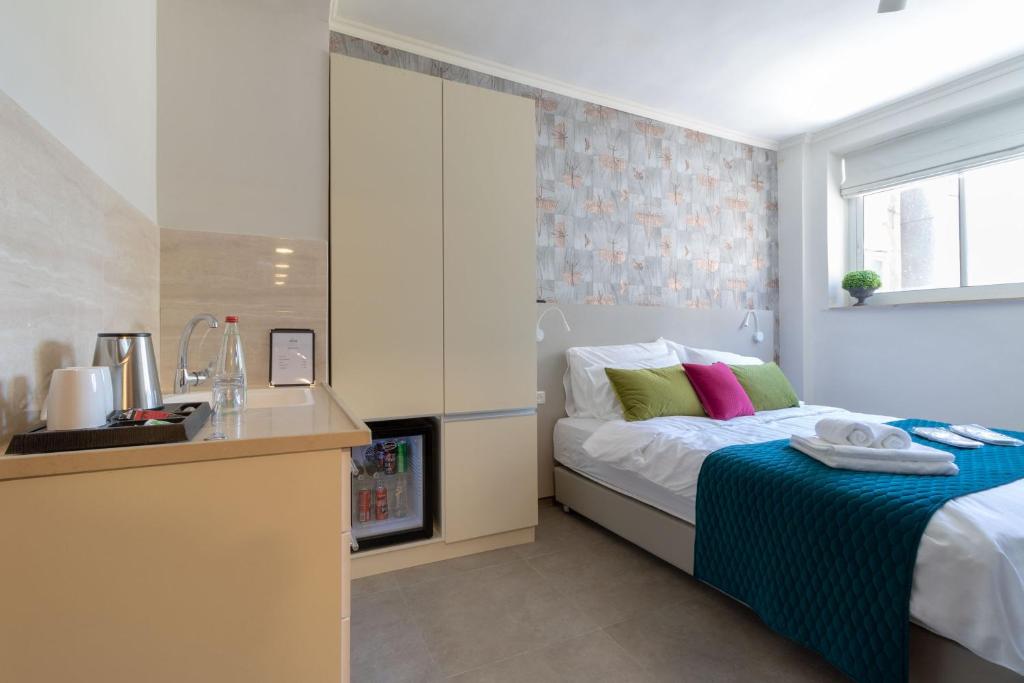Posteľ alebo postele v izbe v ubytovaní DEM Hotel