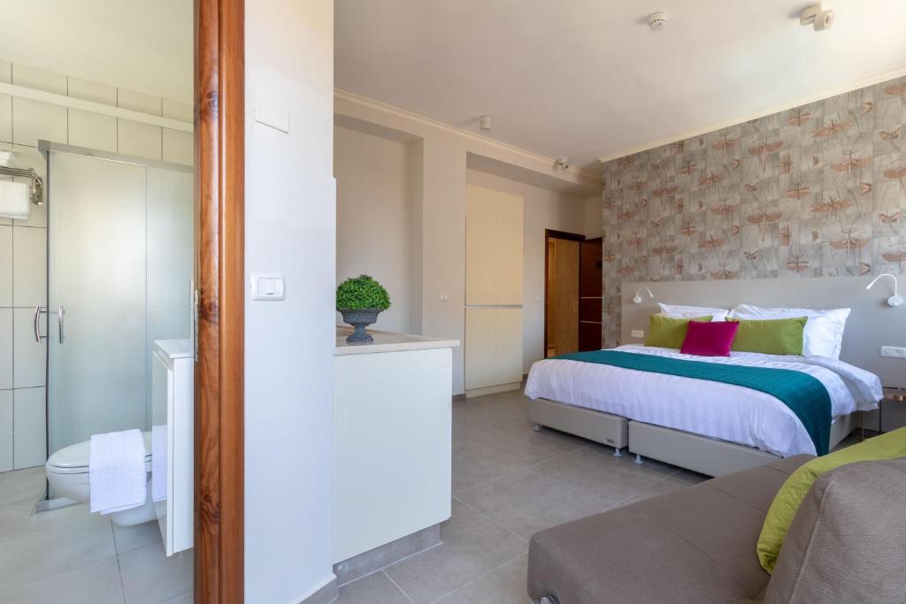 Posteľ alebo postele v izbe v ubytovaní DEM Hotel