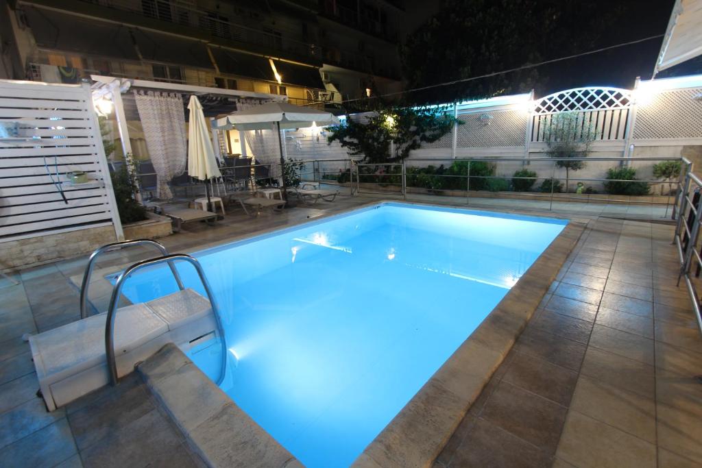 a swimming pool at night with blue lighting at Hotel Mallas in Nea Kalikratia