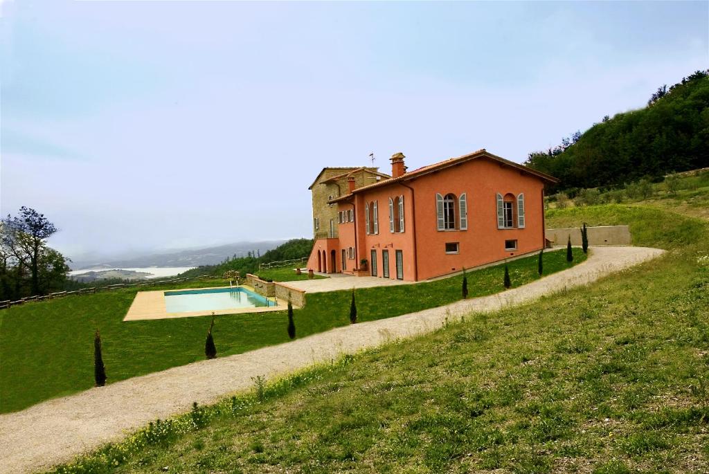 a house on a hill with a swimming pool at Agriturismo Rimaggiori relaxing country home in Barberino di Mugello