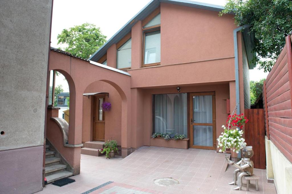 a pink house with a patio in front of it at Petro delux apartments in Kaunas