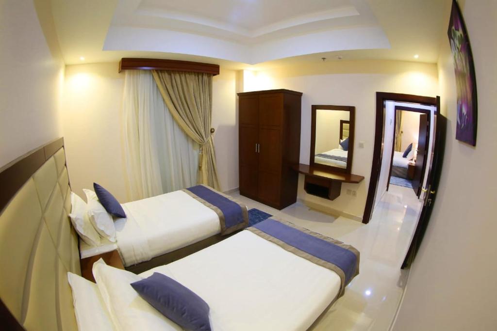 Postel nebo postele na pokoji v ubytování SAS Al Olaya Hotel Suites
