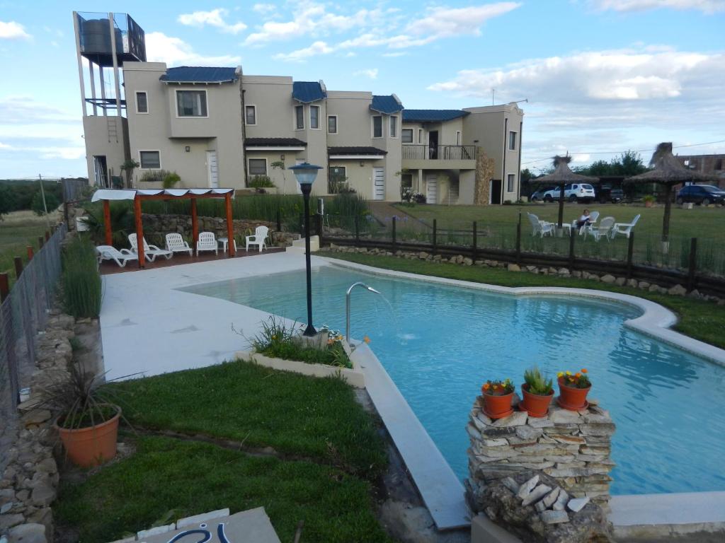 a swimming pool in the backyard of a house at Rio y Piedras in Colón