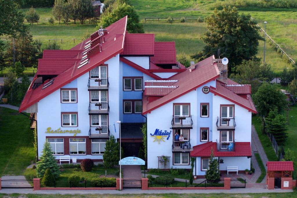 a large house with red roofs at Mikolaj in Białogóra