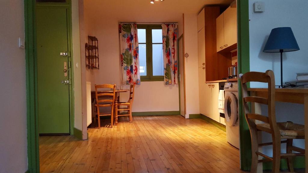 a kitchen and dining room with a table and chairs at Le Velo Rouge in Le Puy en Velay